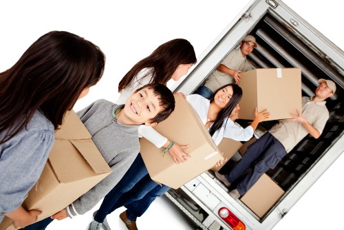 Boxes and furniture being assessed for a transparent storage quote