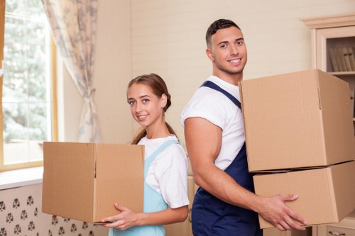 Professional movers handling boxes during a flat removal